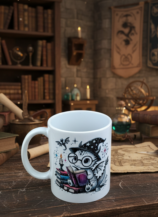 Close-up of white ceramic mug depicting a spotted dragon wizard on a pile of coloured books in a dimly lit library.