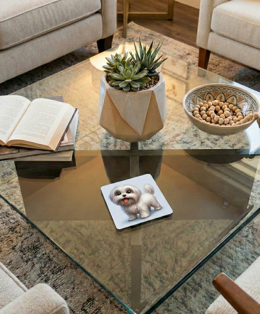 Cartoon white fluffy Maltipoo dog coaster on a glass coffee table beside books and a ceramic succulent pot.
