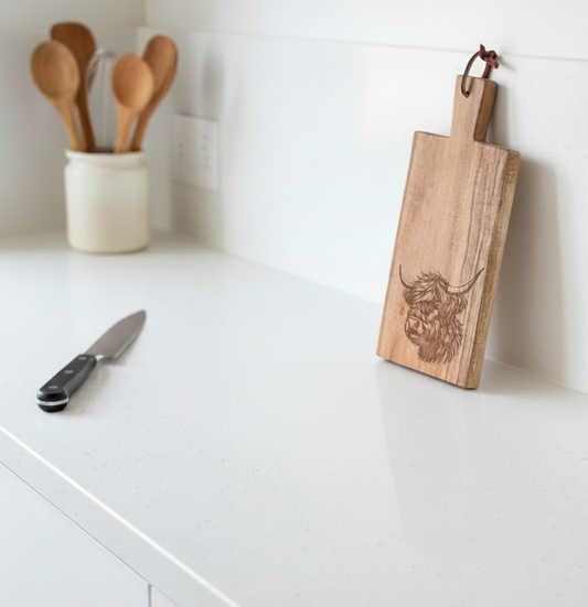 Light brown wooden serving board with a Highland cow head engraving, 