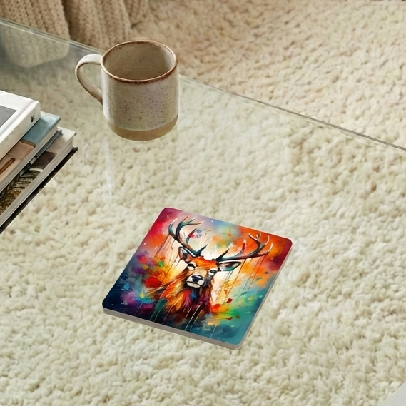 Square coaster with a vivid, multicolour splash-art painting of a stag with large antlers. Speckled ceramic mug in the background.
