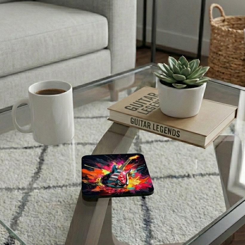 Vibrant guitar-themed coaster on a glass table beside a white coffee mug and a book with a green succulent.