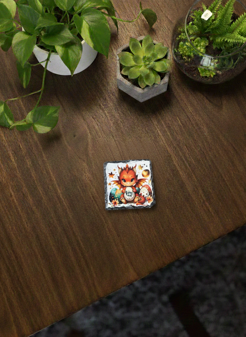 Square slate coaster displaying a cheerful red and orange cartoon dragon surrounded by Easter eggs.