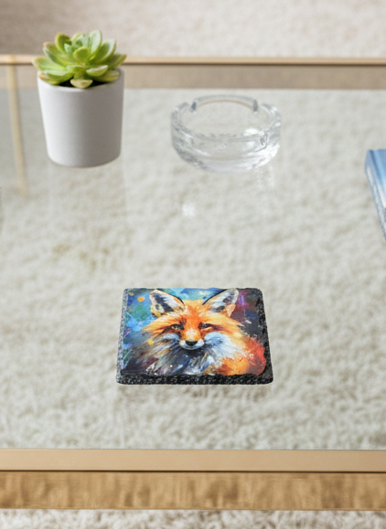 Square slate coaster featuring an impressionistic painting of a reddish-orange fox on a dark background. Next to a potted succulent.