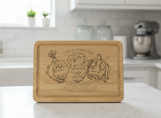 Light natural wood cutting board, engraved with a chef caricature, screaming onion, and pumpkin in a white kitchen.