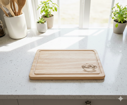 Rectangular pale wood cutting board with rounded corners and juice groove on white speckled quartz, illuminated by sunlight.