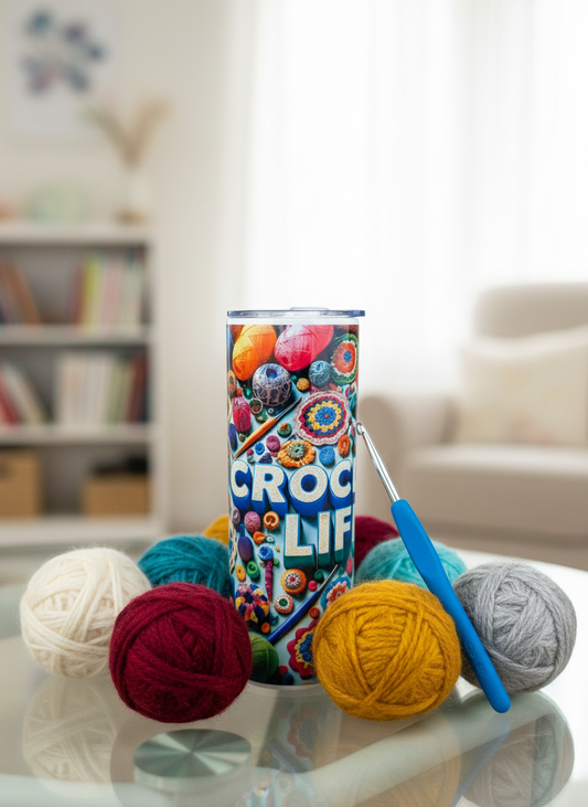 Colourful 'Crochet Life' tumbler with soft balls of wool in burgundy, mustard and grey, plus a blue crochet hook.
