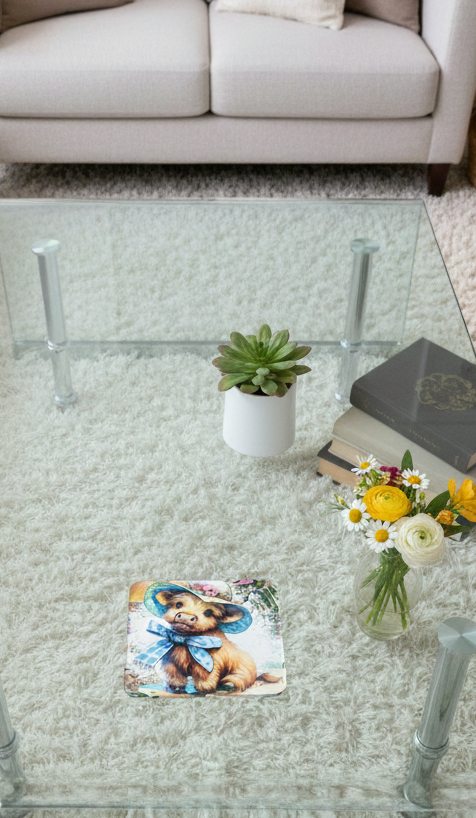 Baby cow coaster with a blue bow on a glass table, near white and yellow flowers with a shaggy rug background.