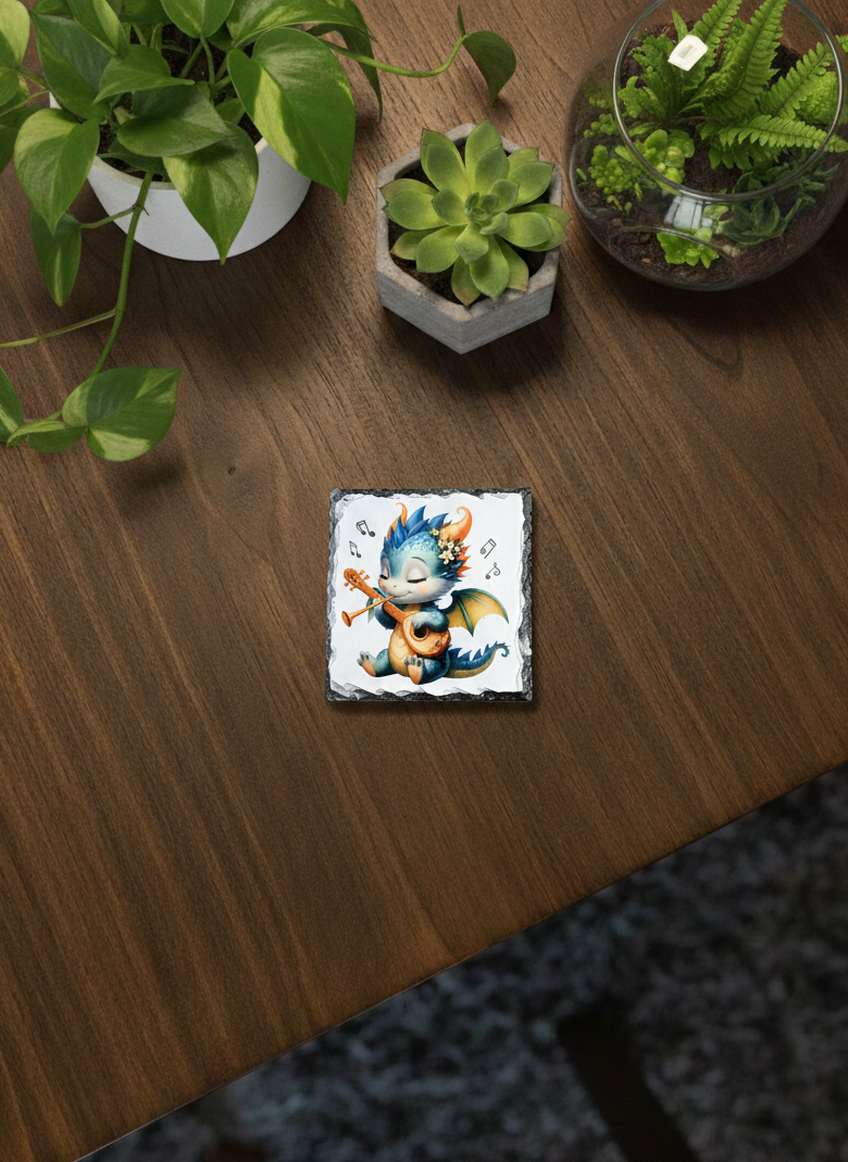 A square slate coaster showing a light blue and yellow cartoon dragon playing a small guitar. Musical notes float around it.
