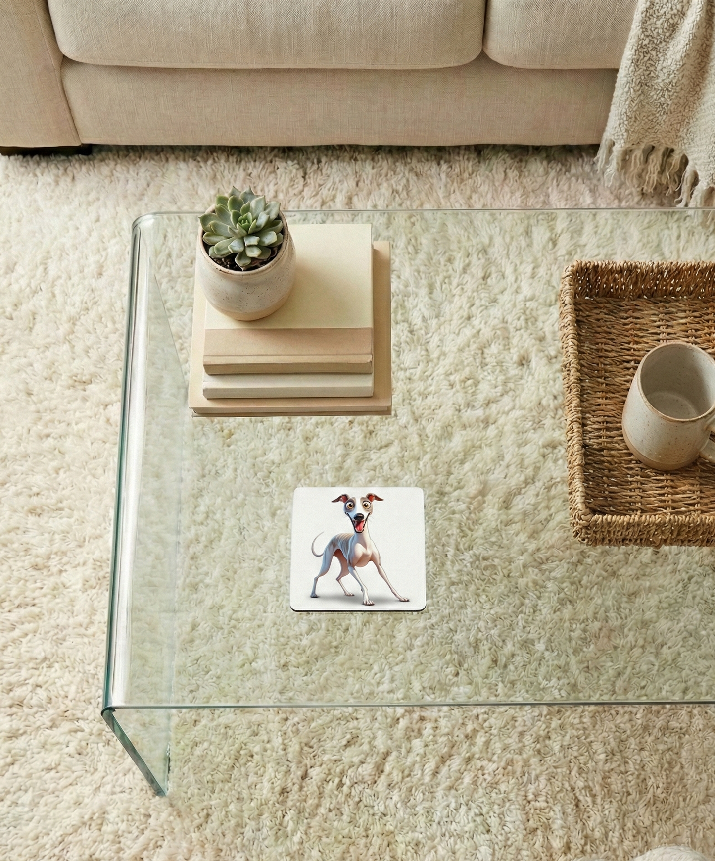 Slender Italian Greyhound dog coaster on a glass table. A succulent pot and art books sit on a cream rug.