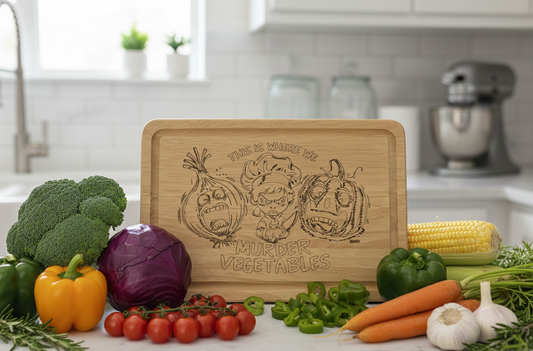Engraved wooden chopping board stands amid a colourful array of raw vegetables: red cabbage, broccoli, peppers, and corn.