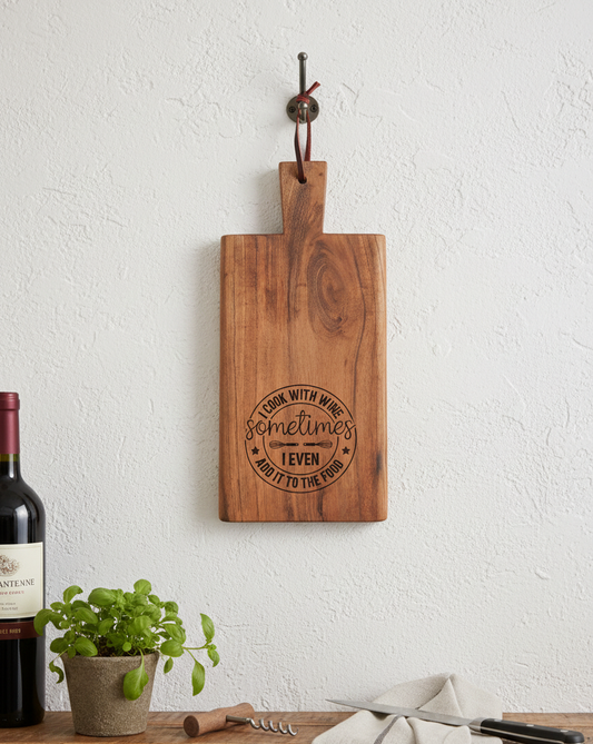 Rich brown wooden cutting board with black circular engraving hangs on a textured white wall using a dark metal hook.