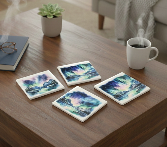 Set of four square coasters with vibrant northern lights watercolour art on a brown wooden table with a white mug.